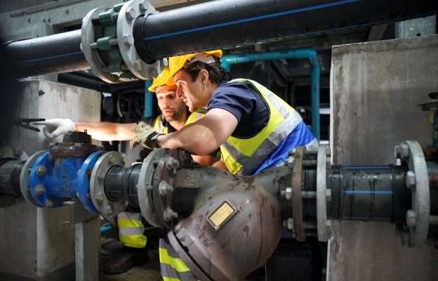Emergency Pipe Repair being carried out by engineers inspecting industrial pipework and valves in a plant room.