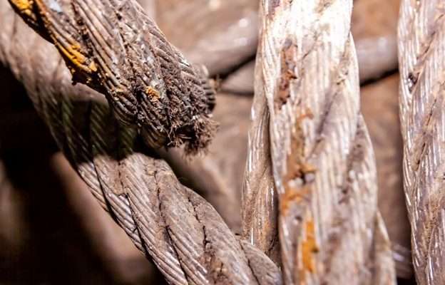 How Wire Rope Corrosion Develops And What It Means For Your Equipment Wire Rope Corrosion visible as surface deterioration and rust on twisted steel wire rope strands used in industrial lifting equipment.